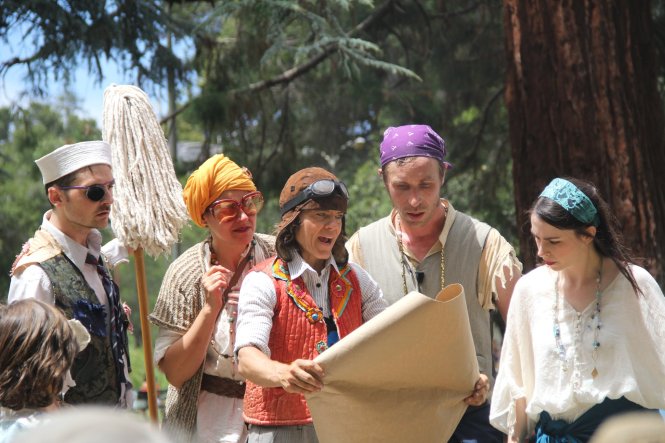 The Players gather around a large paper map, trying to decide their next move.